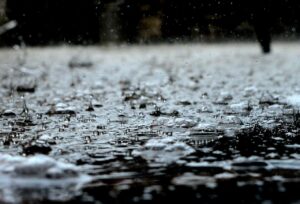 Close-up view from the ground of rain falling on pavement